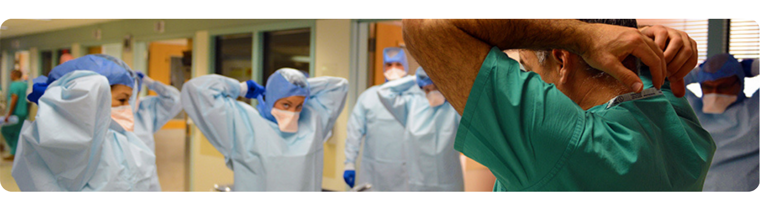 Doctors putting on their surgical robes