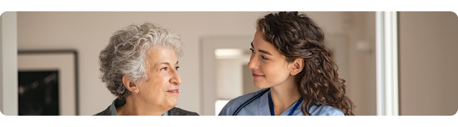 Nurse smiling with elderly patient